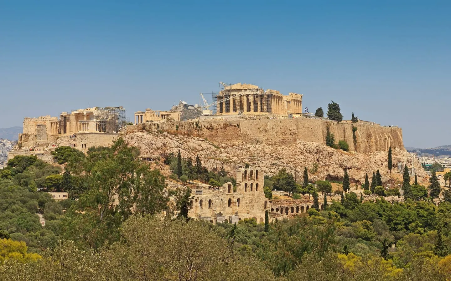 The Acropolis hill with the Parthenon on top, seen across the pine trees of Philopappos Hill