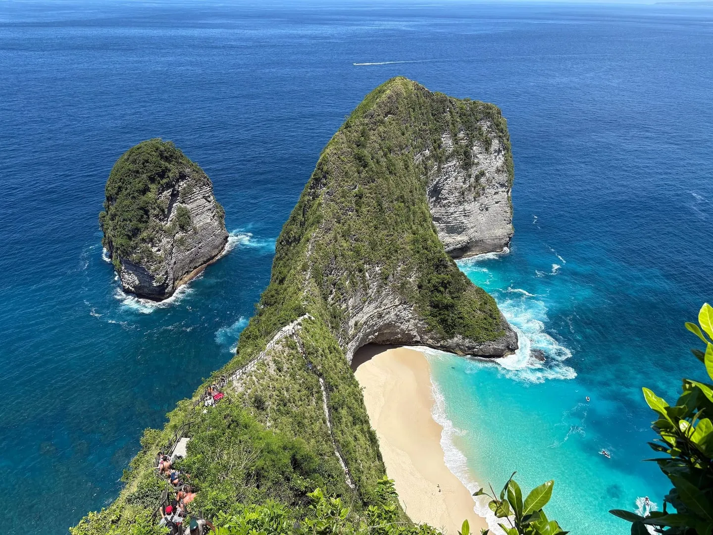 The T-shaped headland and white beach of Kelingking on Nusa Penida seen from the clifftop viewpoint