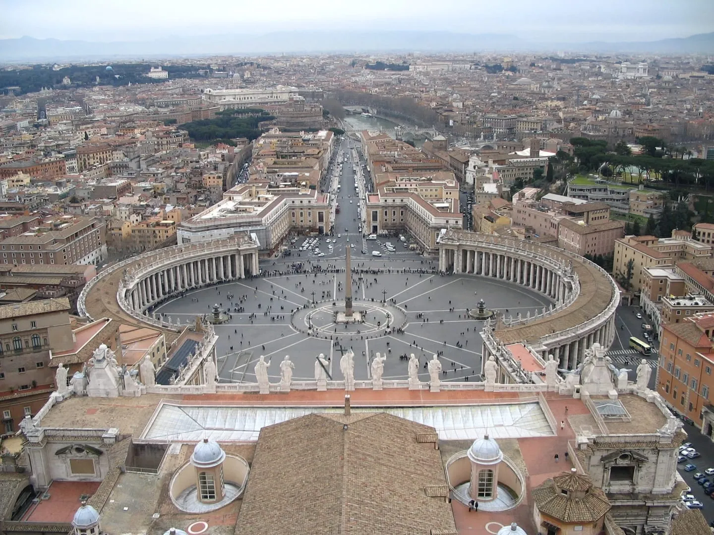 St. Peter’s Square seen from the dome of St. Peter’s Basilica, with its curved colonnades and the long avenue toward the Tiber