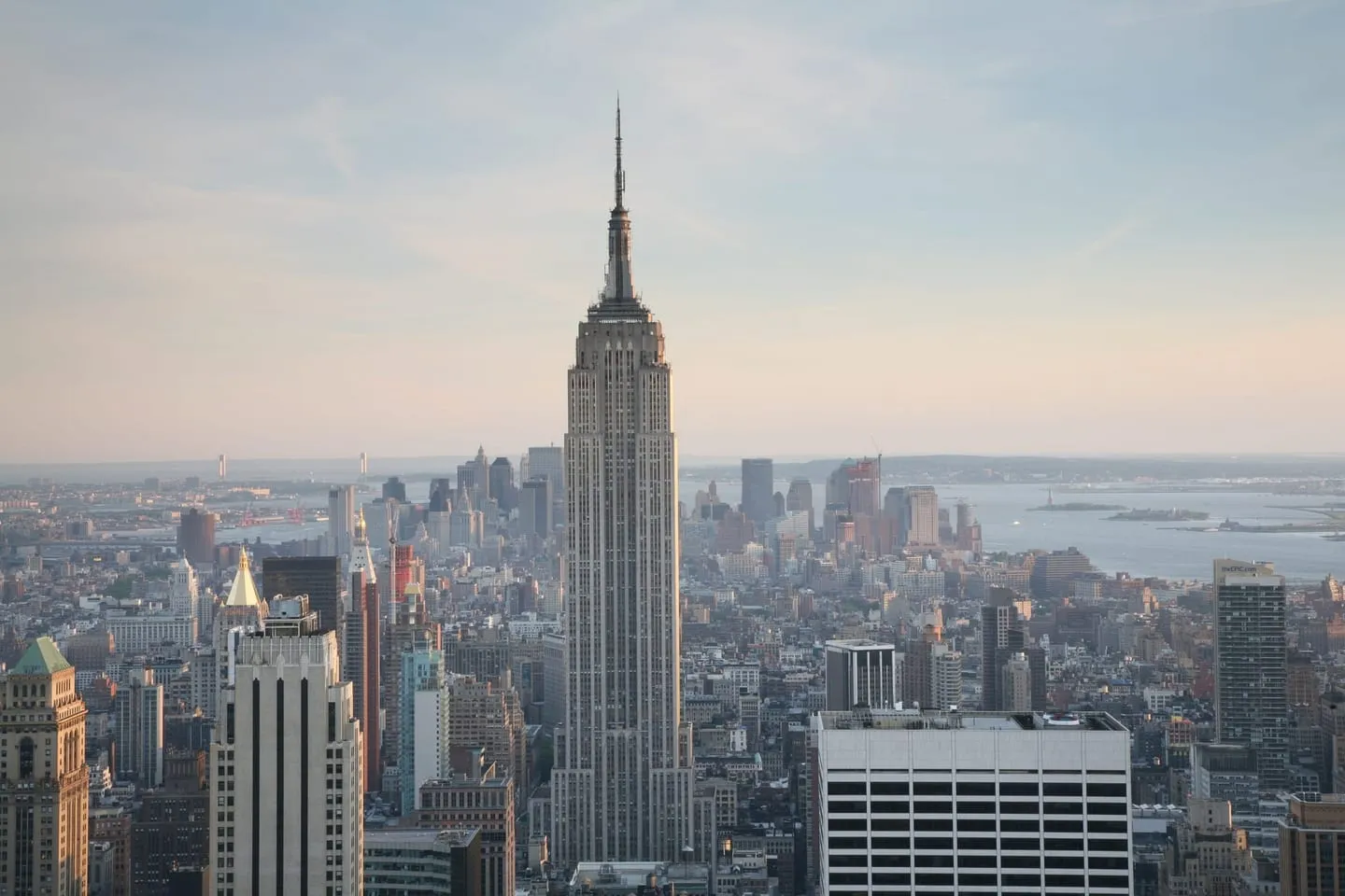 The Empire State Building rising above Midtown with Lower Manhattan and the harbor behind it, seen from Top of the Rock