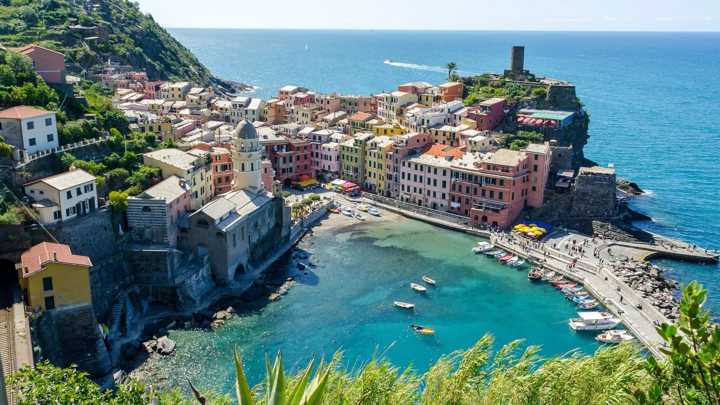 Vernazza’s pastel houses around its small harbor, seen from the coastal trail above the village
